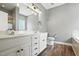 Bright main bathroom featuring double sinks, modern lighting, and separate tub and shower at 456 Majestic Oak Dr, Garner, NC 27529
