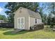 Charming backyard shed with double doors and a shingled roof, providing ample storage space at 456 Majestic Oak Dr, Garner, NC 27529