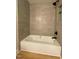 Bright bathroom featuring a tub with sleek black fixtures and light-colored tiling at 510 May St, Gibsonville, NC 27249