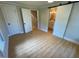 Bedroom with light colored walls and wood floor, sliding door to bath, door to hall, door to closet at 510 May St, Gibsonville, NC 27249
