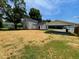 Exterior view of the home with a spacious yard, detached carport, and fresh cut lawn at 510 May St, Gibsonville, NC 27249