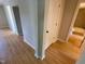 View of the hallway with updated flooring, neutral paint, and views into a bathroom at 510 May St, Gibsonville, NC 27249