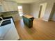 Bright, open kitchen with butcher block island, white cabinets, and mosaic backsplash is great for cooking and entertaining at 510 May St, Gibsonville, NC 27249