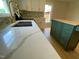Renovated kitchen featuring quartz countertops, mosaic backsplash, and a stylish green kitchen island with butcher block top at 510 May St, Gibsonville, NC 27249