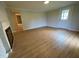 Large living room features neutral paint, new flooring, and a fireplace, creating a cozy atmosphere at 510 May St, Gibsonville, NC 27249