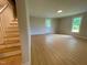 Newly renovated living room featuring staircase, new flooring, neutral paint, and lots of natural light at 510 May St, Gibsonville, NC 27249