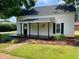 Charming front porch with black painted deck, with hanging plants and sidewalk approach at 510 May St, Gibsonville, NC 27249