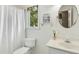 A well-lit bathroom with a sink, toilet, shower with curtain and wall decor at 5301 Denmead Way, Raleigh, NC 27613