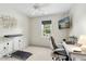 Comfortable bedroom featuring a ceiling fan, work area with computer, and mounted TV at 5301 Denmead Way, Raleigh, NC 27613