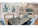 Charming dining room with a dark wood table, elegant chandelier, and views to the living room at 5301 Denmead Way, Raleigh, NC 27613