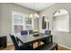 Cozy dining room with modern chandelier, wooden table, and window with white shutters at 5301 Denmead Way, Raleigh, NC 27613