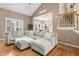 Spacious living room with hardwood floors, large sectional sofa, and ample natural light at 5301 Denmead Way, Raleigh, NC 27613