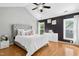 Spacious main bedroom features a vaulted ceiling, hardwood floors, and two windows allowing ample natural light at 5301 Denmead Way, Raleigh, NC 27613
