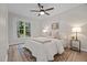 Cozy bedroom with natural light, ceiling fan, and view of wooded landscape at 5721 Meadow, Knightdale, NC 27545