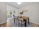 Inviting dining area with modern table set and view into adjoining living room with fireplace at 5721 Meadow, Knightdale, NC 27545