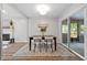 Bright dining area features modern furnishings, sleek lighting, and a sliding glass door to outdoor space at 5721 Meadow, Knightdale, NC 27545