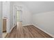 Hallway leading to a bathroom featuring hardwood floors at 5721 Meadow, Knightdale, NC 27545
