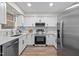 Modern kitchen features white cabinets, stainless steel appliances, and stylish countertops at 5721 Meadow, Knightdale, NC 27545