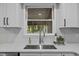 Close up of modern kitchen sink with updated fixtures and outside view at 5721 Meadow, Knightdale, NC 27545