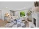 Bright and airy living room with plush seating, modern decor, and large windows overlooking the yard at 5721 Meadow, Knightdale, NC 27545