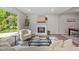 Bright living room features a fireplace, stylish furniture, and plenty of natural light at 5721 Meadow, Knightdale, NC 27545