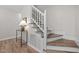 Staircase with white railing and wood steps, creating a classic look at 5721 Meadow, Knightdale, NC 27545