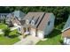 Aerial view of a home featuring well-maintained landscaping, a large yard, and a two-car garage at 5818 Myakka Ct, Raleigh, NC 27616