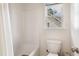 Bathroom features a toilet, shower/tub combo, and window at 5818 Myakka Ct, Raleigh, NC 27616