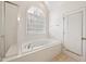 Relaxing bathroom with a whirlpool bathtub, a separate shower, and a window at 5818 Myakka Ct, Raleigh, NC 27616