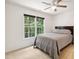 Cozy bedroom with a bed and a large window offering a view of the trees at 5818 Myakka Ct, Raleigh, NC 27616
