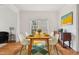 Dining room with hardwood floors, white trim, a modern table, and a window at 5818 Myakka Ct, Raleigh, NC 27616