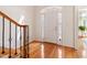 Bright entryway with hardwood floors and decorative glass door and staircase with wood handrail at 5818 Myakka Ct, Raleigh, NC 27616