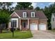 Charming two-story brick home with attached two-car garage and manicured front lawn at 5818 Myakka Ct, Raleigh, NC 27616