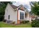 A side view of a well-maintained home featuring a combination of brick and vinyl siding at 5818 Myakka Ct, Raleigh, NC 27616