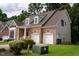 A brick and siding exterior of a two-story home featuring an attached two-car garage and dormer windows at 5818 Myakka Ct, Raleigh, NC 27616