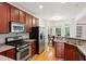 Well-equipped kitchen with stainless steel appliances, custom cabinets, and an adjacent dining area at 5818 Myakka Ct, Raleigh, NC 27616
