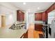 Spacious kitchen with stainless steel appliances, dark wood cabinets, and a breakfast bar at 5818 Myakka Ct, Raleigh, NC 27616