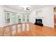 Spacious living room with hardwood floors, a fireplace, and an abundance of natural light at 5818 Myakka Ct, Raleigh, NC 27616