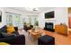Cozy living room featuring a fireplace, ceiling fan, and large windows for ample natural light at 5818 Myakka Ct, Raleigh, NC 27616