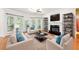 A bright living room featuring hardwood floors, a fireplace, and neutral-toned furniture at 5818 Myakka Ct, Raleigh, NC 27616