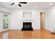 Living room featuring hardwood floors, fireplace, ceiling fan, and a window to allow natural light at 5818 Myakka Ct, Raleigh, NC 27616