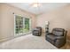 Comfortable living room featuring two leather recliners, neutral carpet, and a large window at 5818 Myakka Ct, Raleigh, NC 27616