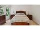 Well-lit main bedroom featuring a bed, side tables, and a dresser at 5818 Myakka Ct, Raleigh, NC 27616