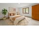 Serene bedroom featuring a cozy queen bed, stylish rug, and natural light from the window with tree views at 601 Wofford Rd, Durham, NC 27707