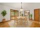 Cozy dining room showcasing hardwood floors, a stylish chandelier, and views into the screened porch and kitchen at 601 Wofford Rd, Durham, NC 27707