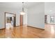 Dining room with hardwood floors, a chandelier, and doorways that lead to the kitchen at 601 Wofford Rd, Durham, NC 27707