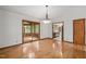 Dining room with hardwood floors, a decorative chandelier, and access to the kitchen and porch at 601 Wofford Rd, Durham, NC 27707