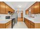 Functional kitchen featuring wood cabinetry, modern appliances, and plenty of countertop space at 601 Wofford Rd, Durham, NC 27707