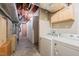 Unfinished basement laundry with washer, dryer, exposed ductwork, and built in cabinets at 601 Wofford Rd, Durham, NC 27707