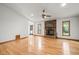 Open living room with hardwood floors and stone fireplace offers a perfect space for relaxation and entertaining at 601 Wofford Rd, Durham, NC 27707